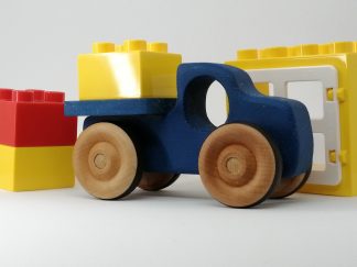 Photo of blue wooden pickup toy with other toys