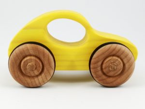 brightly coloured yellow wooden toy car